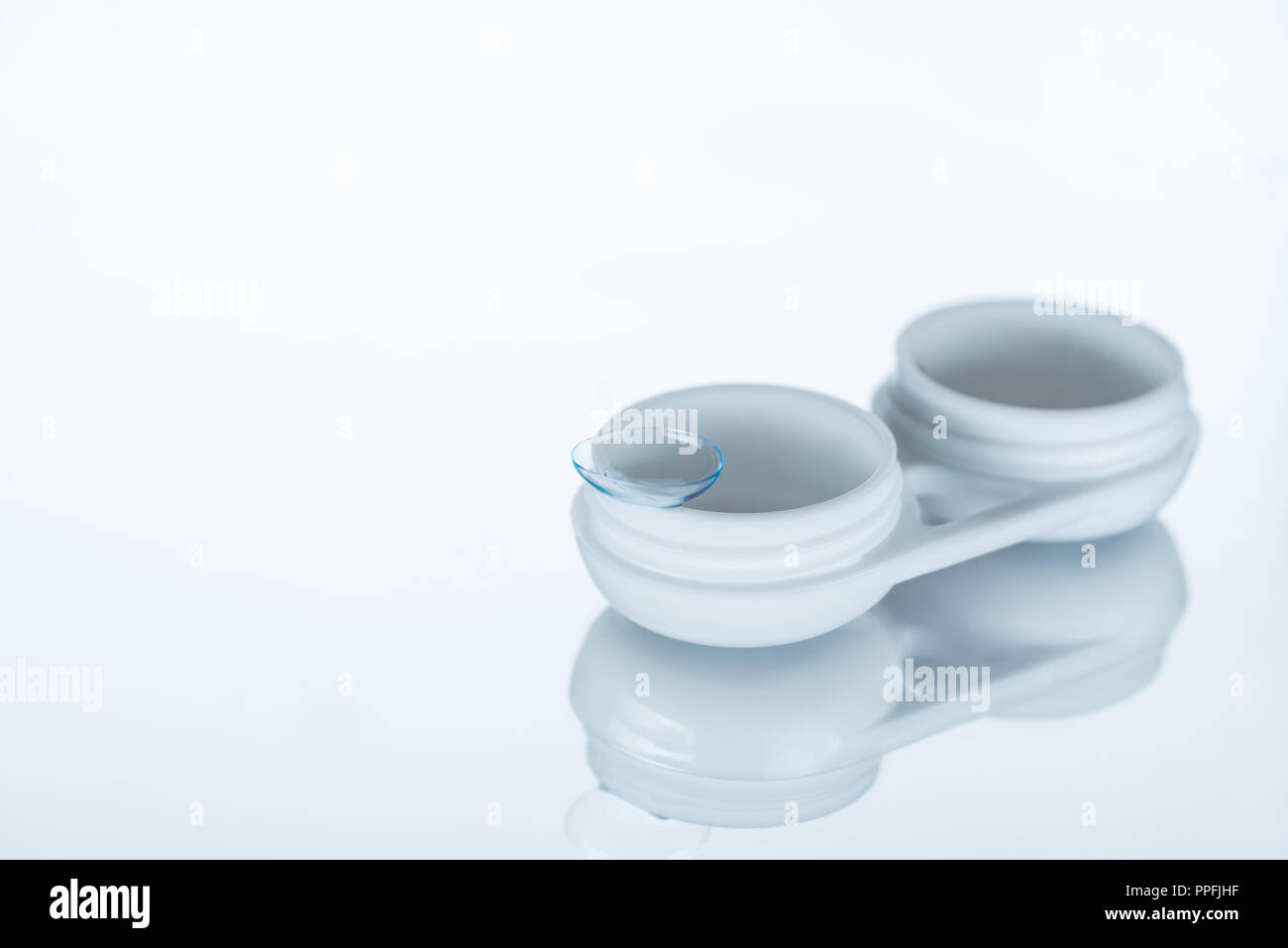 close up view of contact lense and container on white background Stock Photo