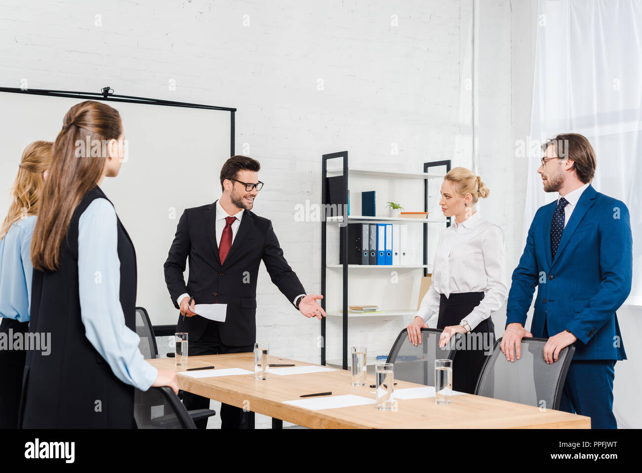team of boss and managers having conversation at modern office Stock