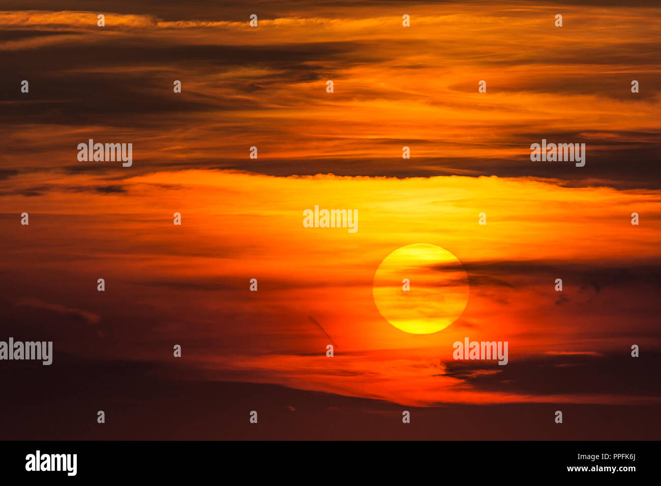 Glowing sun, sunset with clouds, evening sky, Germany Stock Photo