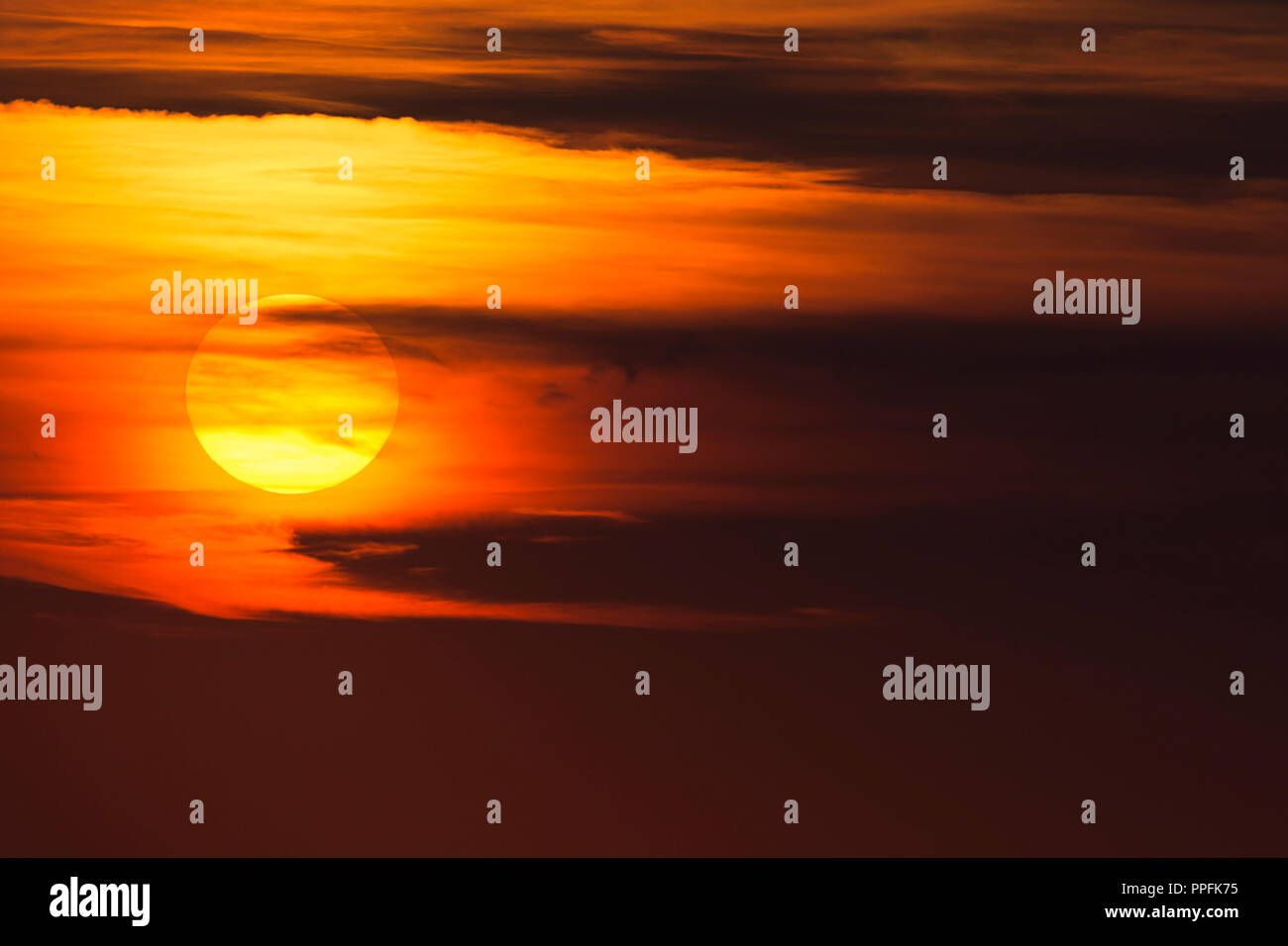 Glowing sun, sunset with clouds, evening sky, Germany Stock Photo