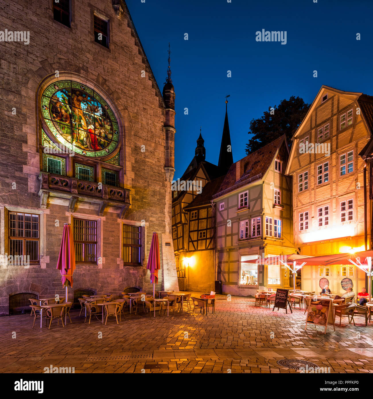 Window with enlightened stained glass at the town hall, half-timbered houses, night scene, UNESCO World Heritage Site Stock Photo