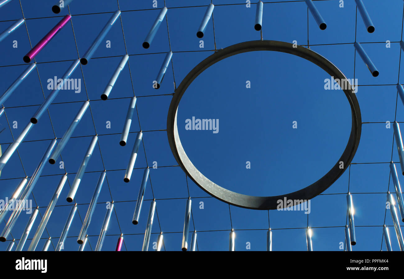 Metal rods (planks) and ring hoop hanging against blue sky modern