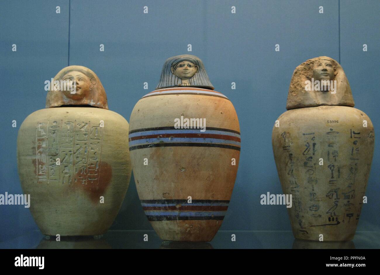 Polychormed canopic jars. Used by the egyptians during the mummification to preserve the viscera. On the left, painted jar of a child of the Royal Nursery of Ahmose. 1500 BC. From Upper Egypt. In the center, painted jar without inscription. 1450 BC. On the right, jar with hieroglyphic text. 1500 BC. Unknown origin. British Museum. London. United Kingdom. Stock Photo