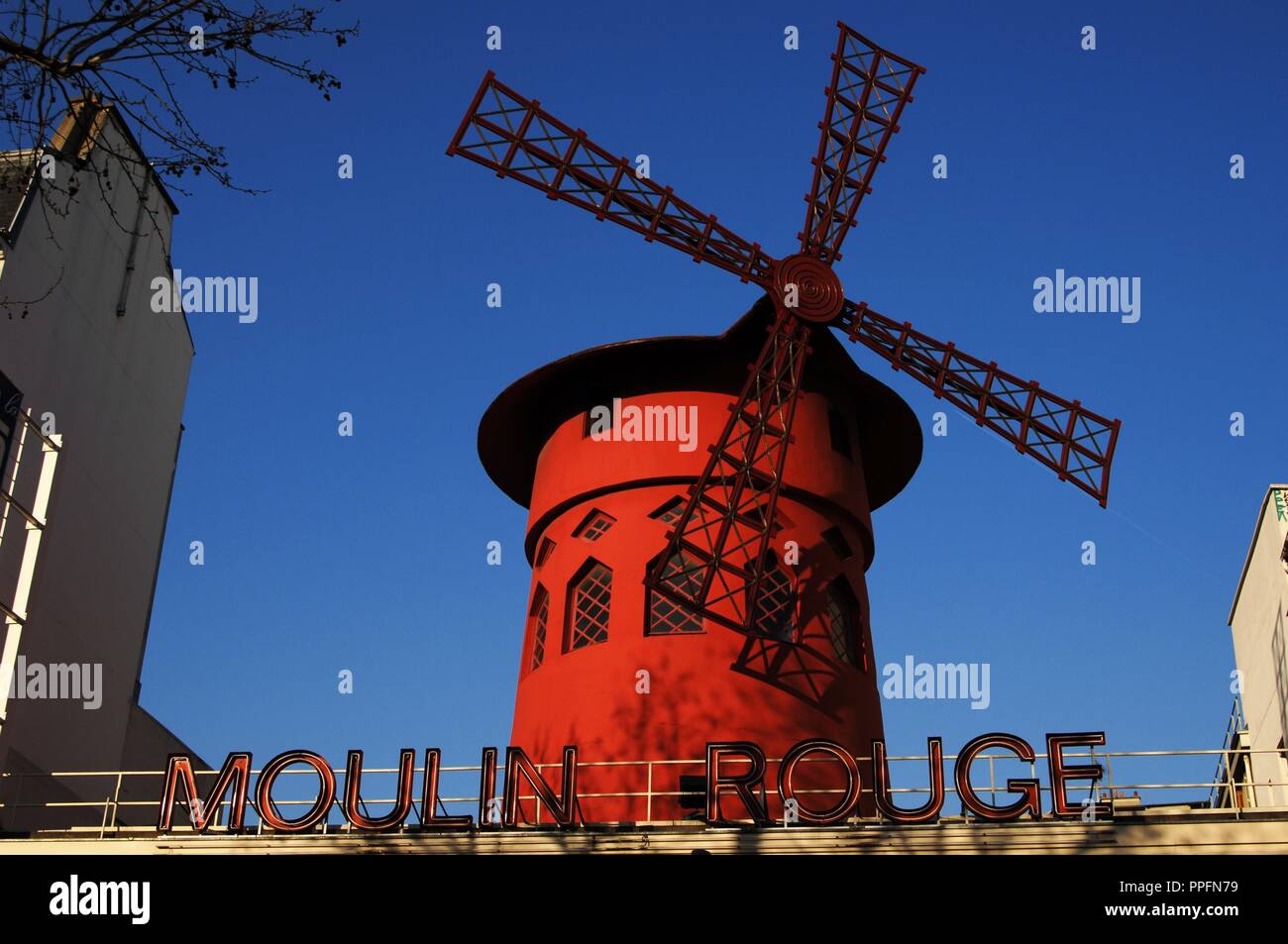 France. Paris. Moulin Rouge. Cabaret, opened in 1889. Built by Adolphe Leon Willette (1857-1926) and Edouard-Jean Niermans (1859-1928). Marked by the red windmill on its roof. Detail. Exterior. Pigalle district. Stock Photo