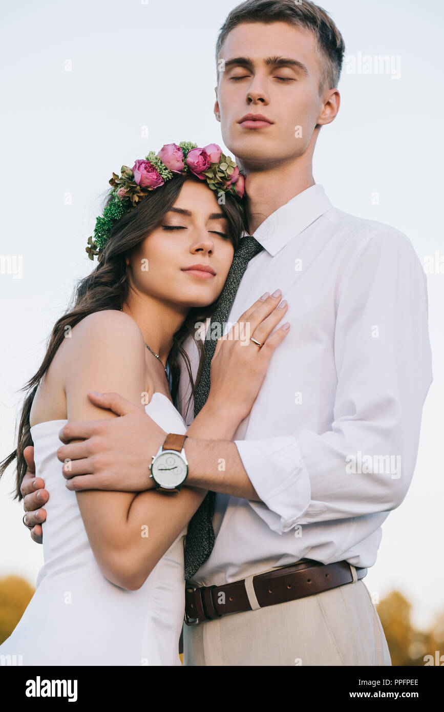 Low Angle View Of Beautiful Romantic Young Wedding Couple