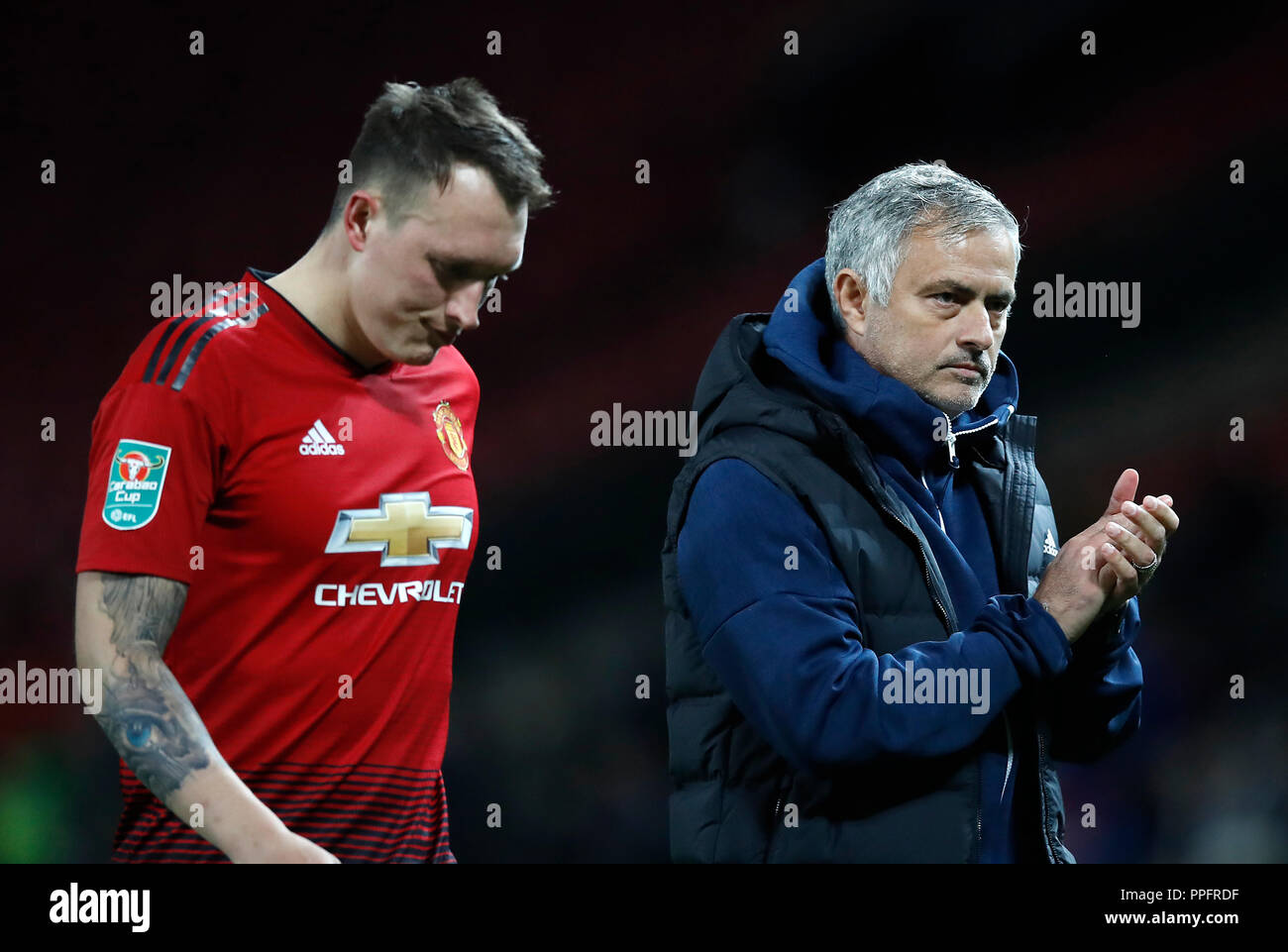 Manchester United's Phil Jones (left) and manager Jose Mourinho (right) appears dejected after the penalty shootout during the Carabao Cup, third round match at Old Trafford, Manchester. PRESS ASSOCIATION Photo. Picture date: Tuesday September 25, 2018. See PA story SOCCER Man Utd. Photo credit should read: Martin Rickett/PA Wire. RESTRICTIONS: EDITORIAL USE ONLY No use with unauthorised audio, video, data, fixture lists, club/league logos or 'live' services. Online in-match use limited to 120 images, no video emulation. No use in betting, games or single club/league/player publications Stock Photo