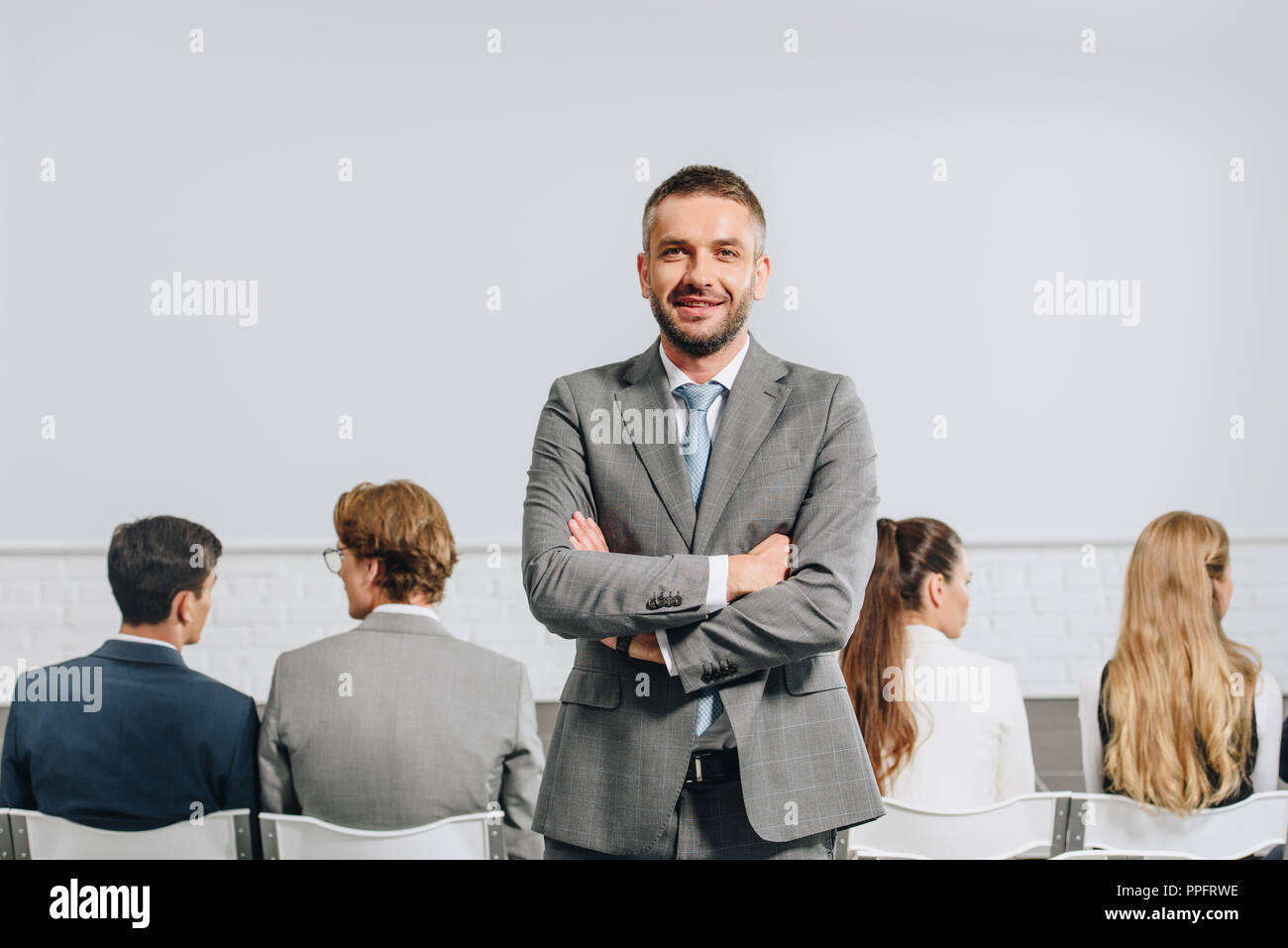 Female coach arms crossed hi-res stock photography and images - Alamy