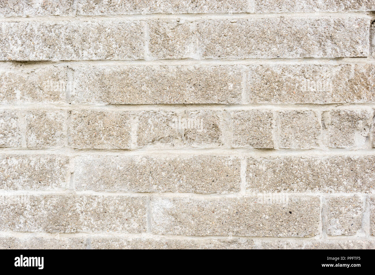 aged weathered block wall. old brick background. Stock Photo
