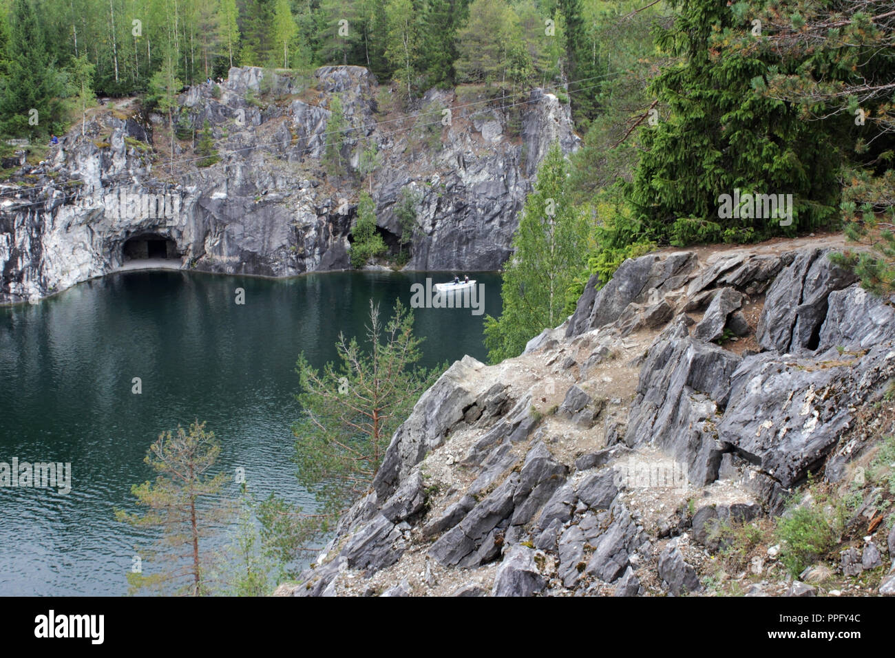 Ruskeala marble quarry, Karelia, Russia. turquoise water in the river and gray with white veins of the shore, forest. Stock Photo