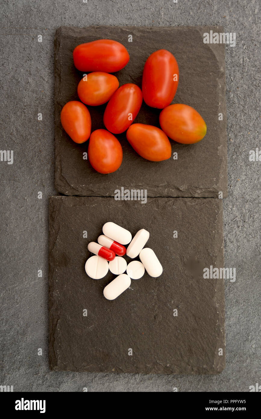 conceptual disjunctive between medicines or fruits and vegetables Stock Photo