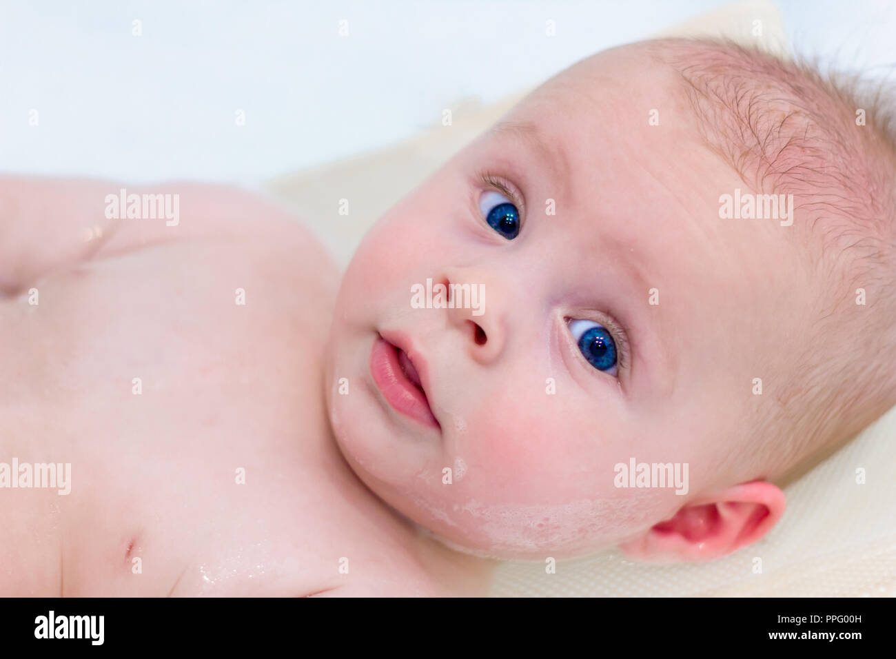 6 month baby boy taking a bath. Little child in a bathtub. Infant washing and bathing