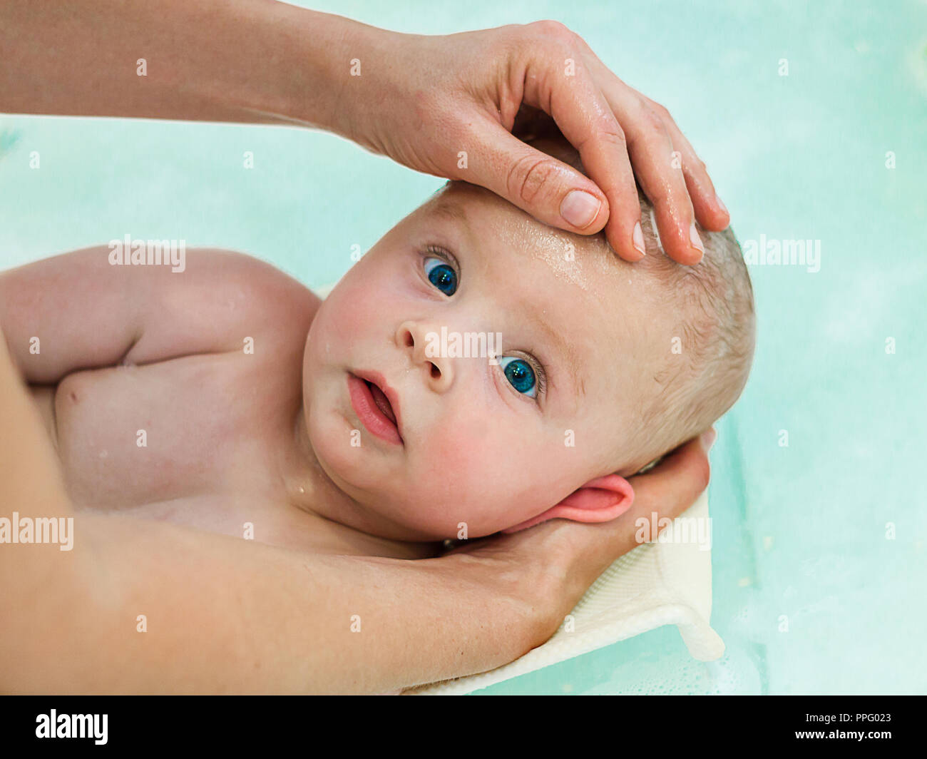 6 month baby boy taking a bath. Little child in a bathtub. Infant washing and bathing