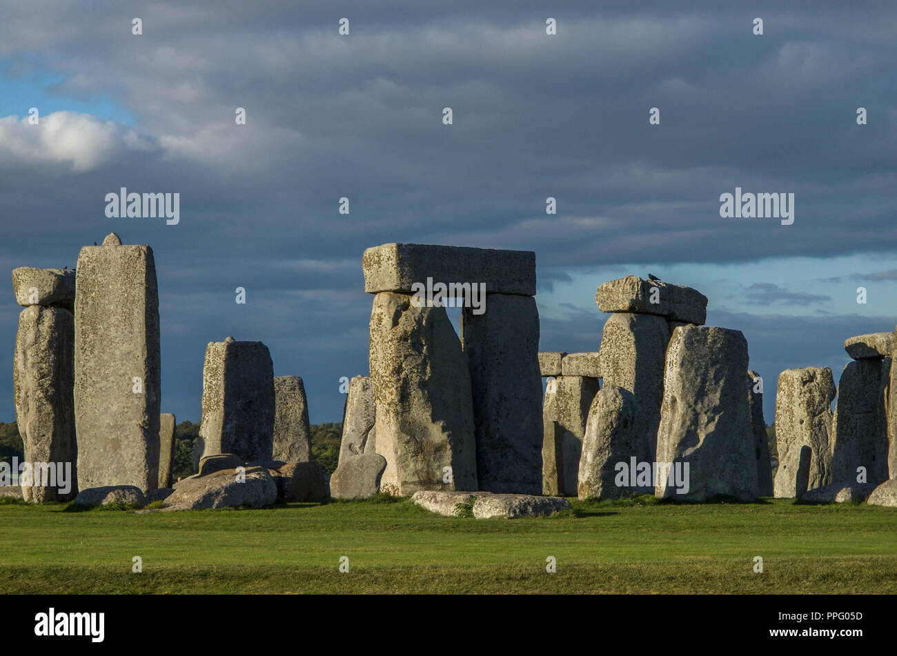 Stonehenge in late afternoon sun with darkening clouds Stock Photo