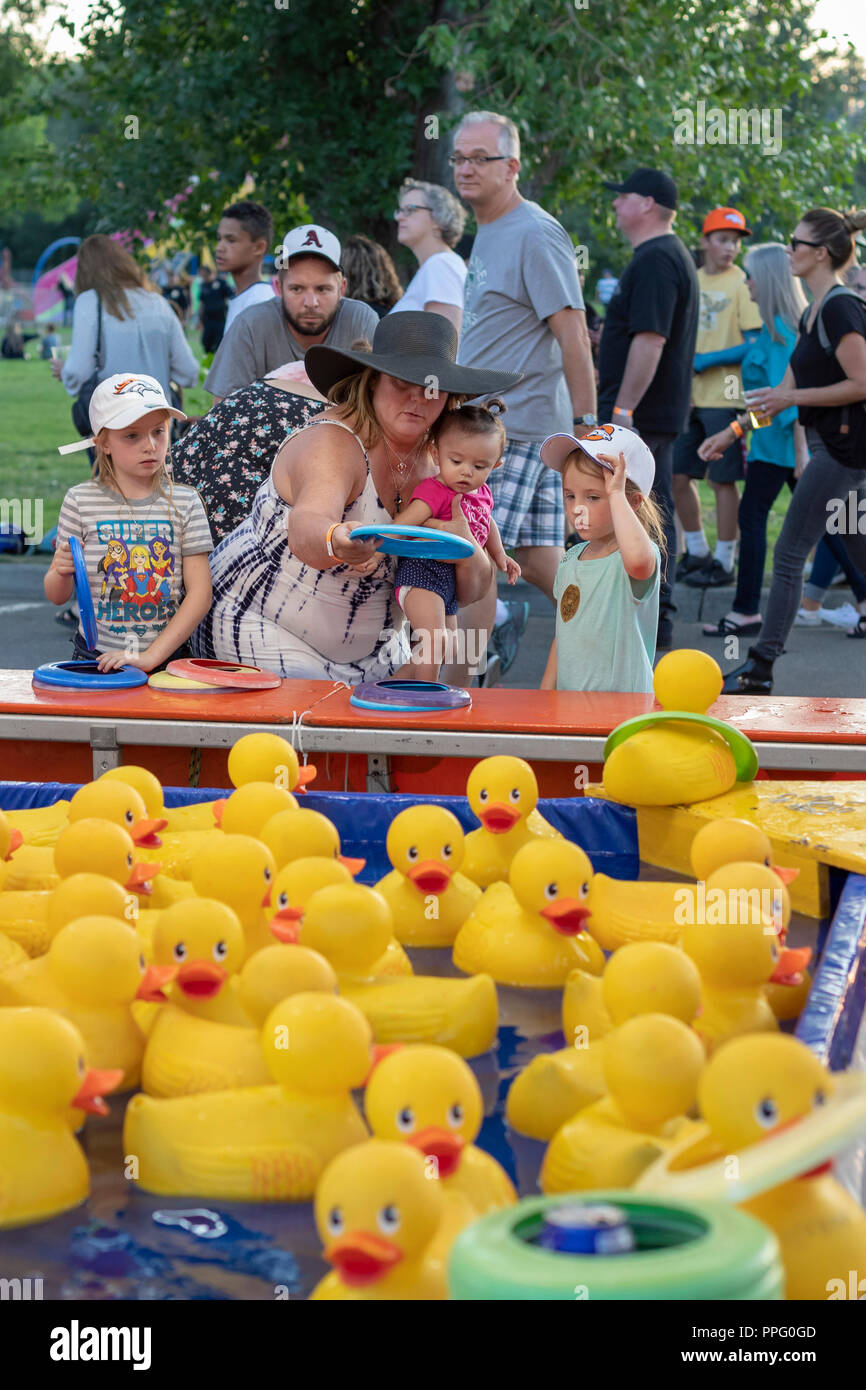 Wheat Ridge, Colorado A woman helps a baby try to win a prize during