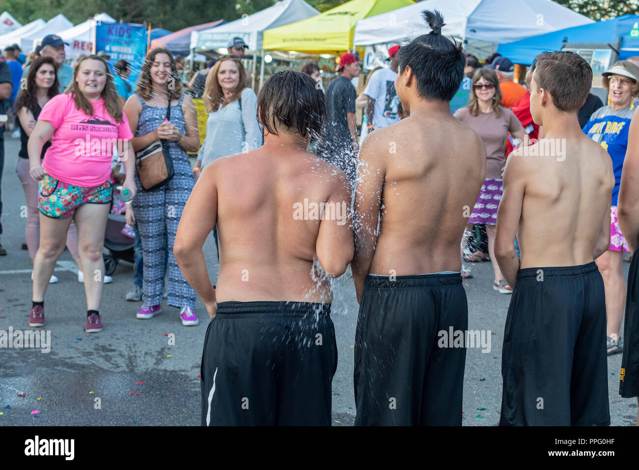 Wheat Ridge, Colorado - High school boys get pelted with water balloons as a charity fundraiser during the annual Carnation Festival. The festival fea Stock Photo