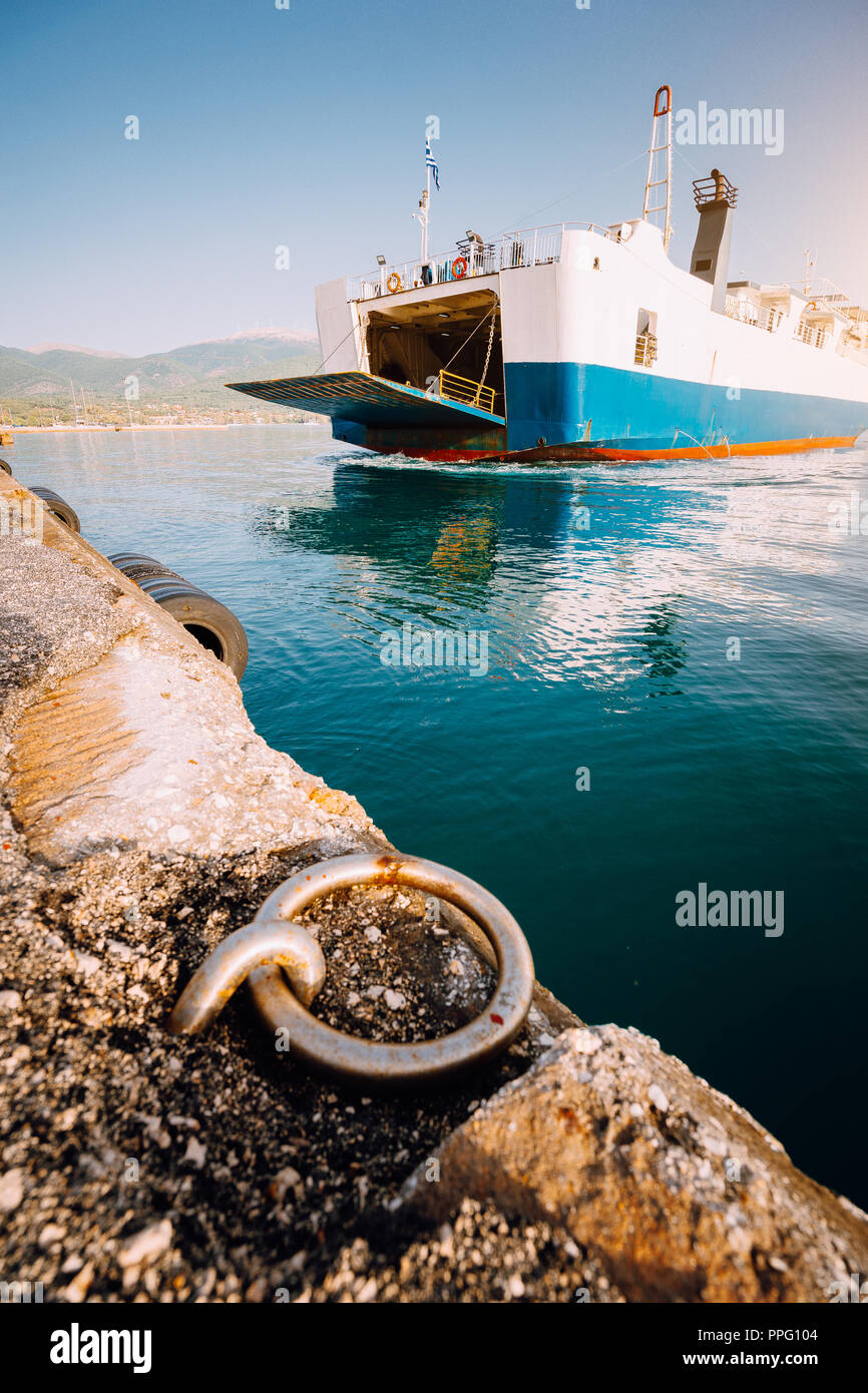 Big ferry boat with passengers and cars arrives beautiful Greek island