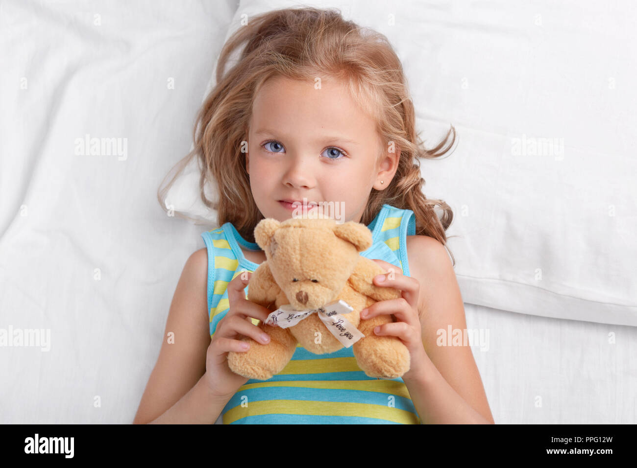 Beautiful African Young Woman Wearing Pajama, Holding Teddy Bear and  Drinking Coffee Looking at the Camera Blowing a Kiss Being Stock Image -  Image of emotion, wearing: 221141211
