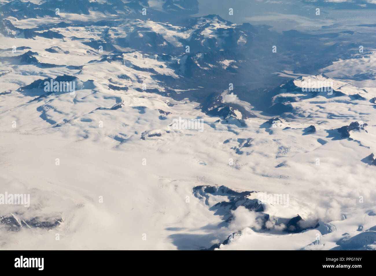 Ariel view of a snow covered mountain range Stock Photo