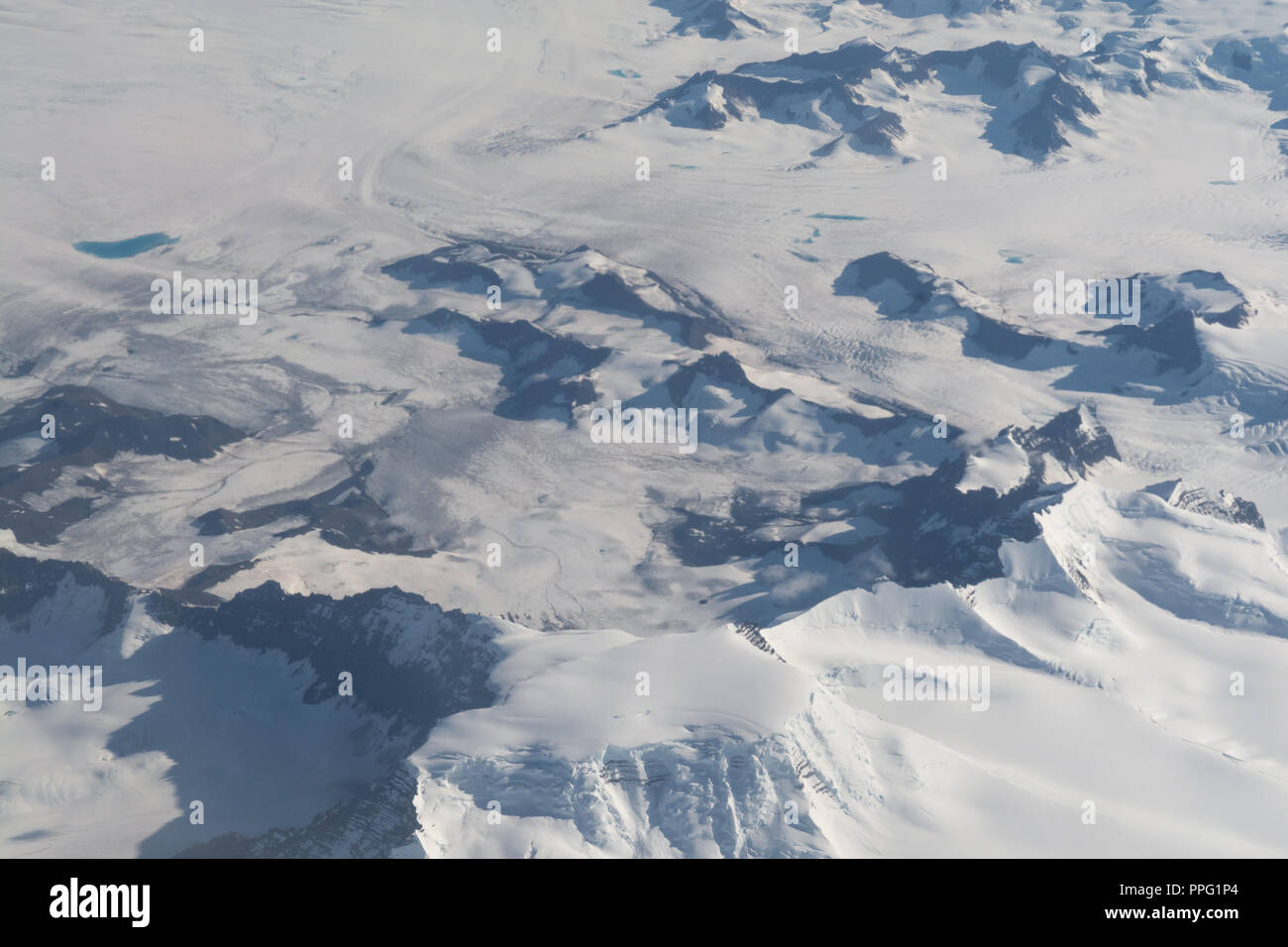 Ariel view of a snow covered mountain range Stock Photo
