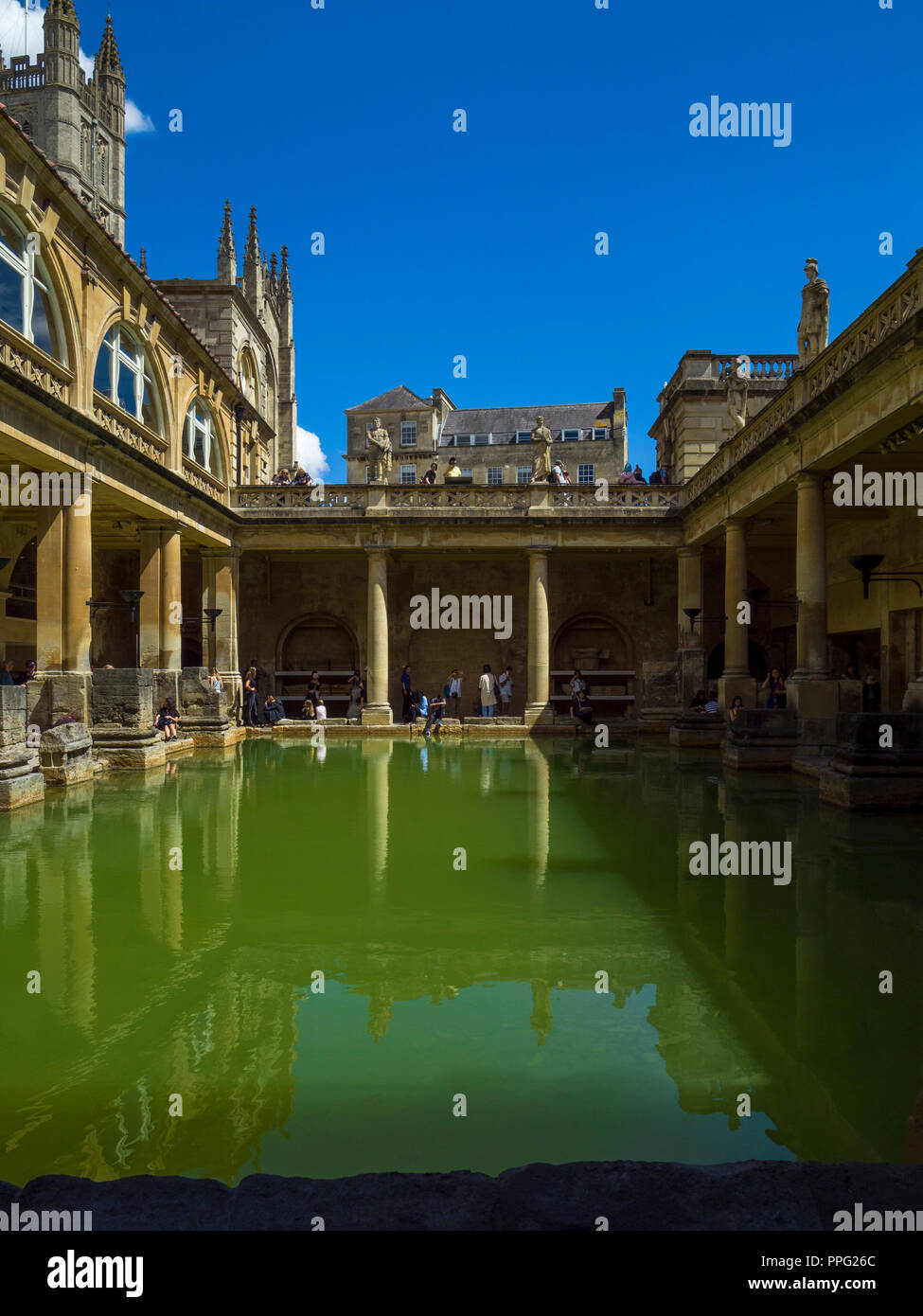 Historic Great Bath of the Roman Baths with Bath Abbey in background (left), Bath, Somerset