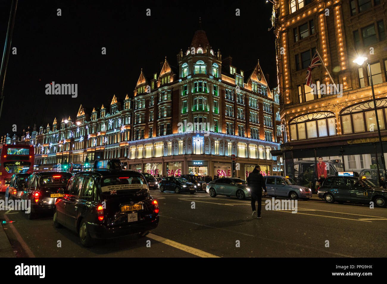 London, United Kingdom - January 3, 2018: Street of the luxurious district of Knightsbridge at night with Christmas decoration with people around in L Stock Photo