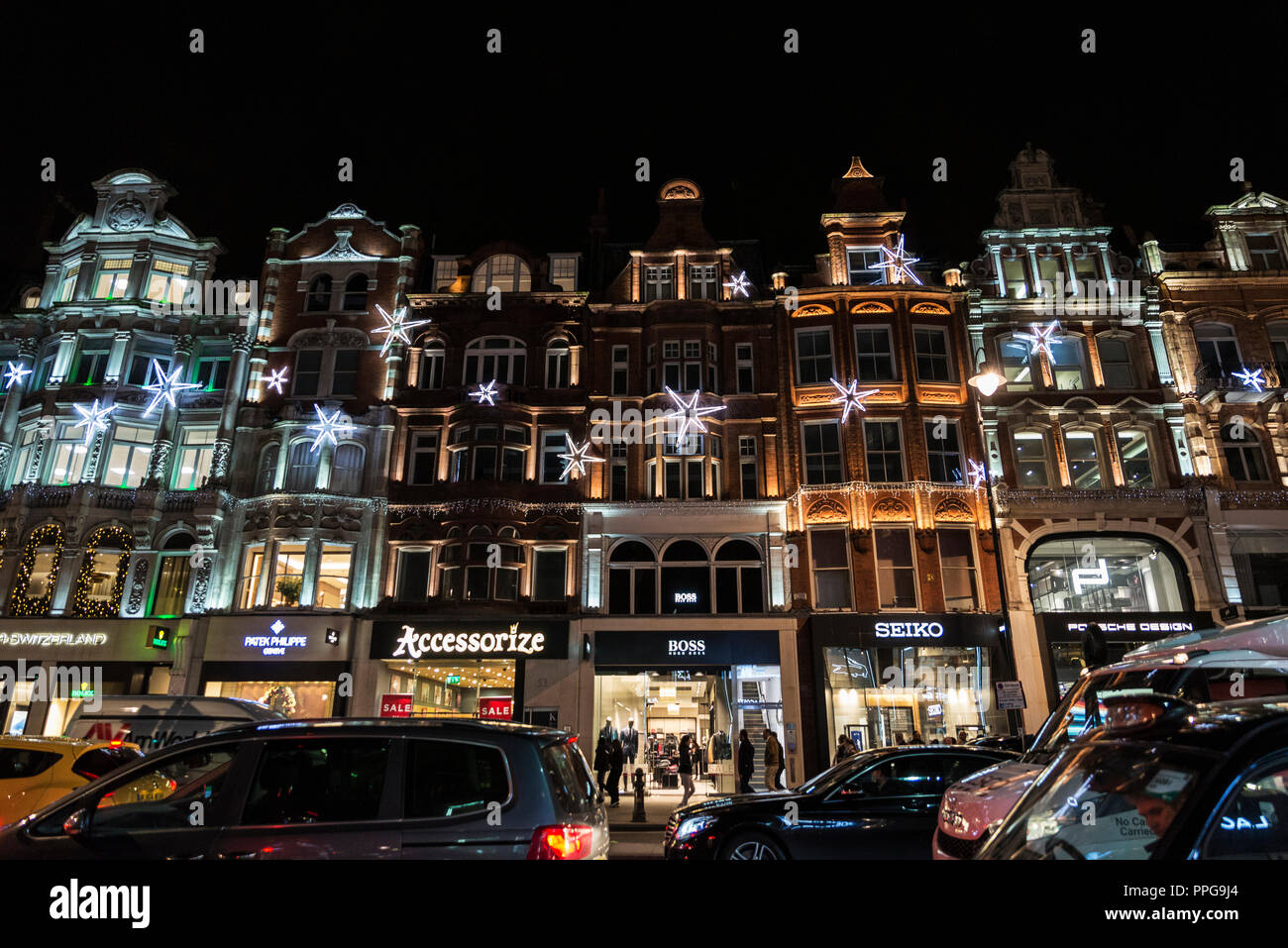 London, United Kingdom - January 3, 2018: Street of the luxurious district of Knightsbridge at night with Christmas decoration and people around in Lo Stock Photo