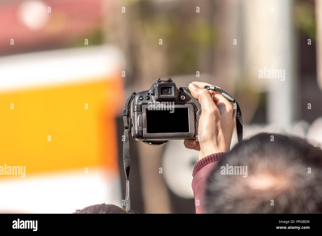 Person using his camera to photograph an event Stock Photo
