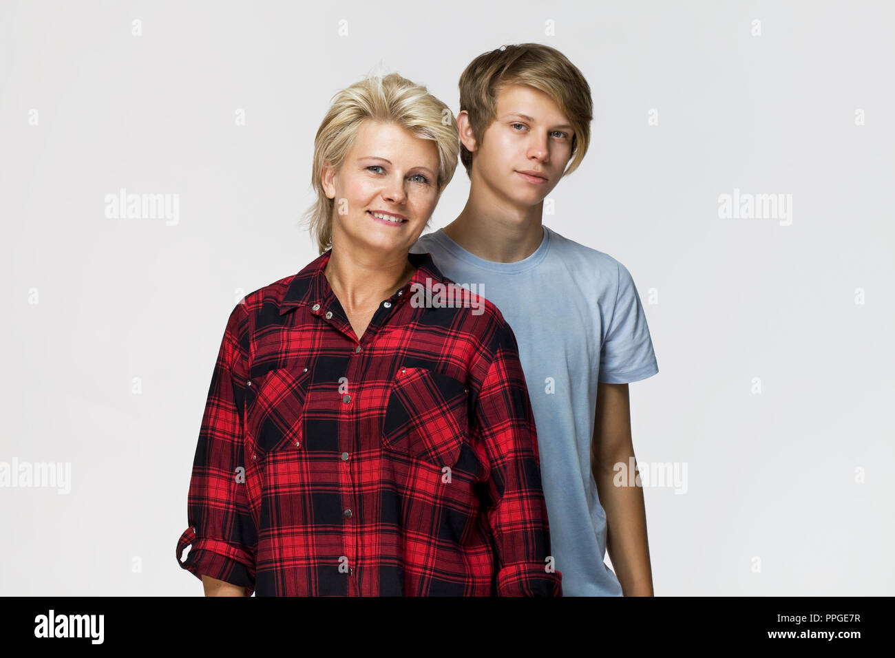 Happy and smiling mother and son. Loving family portrait against white background Stock Photo
