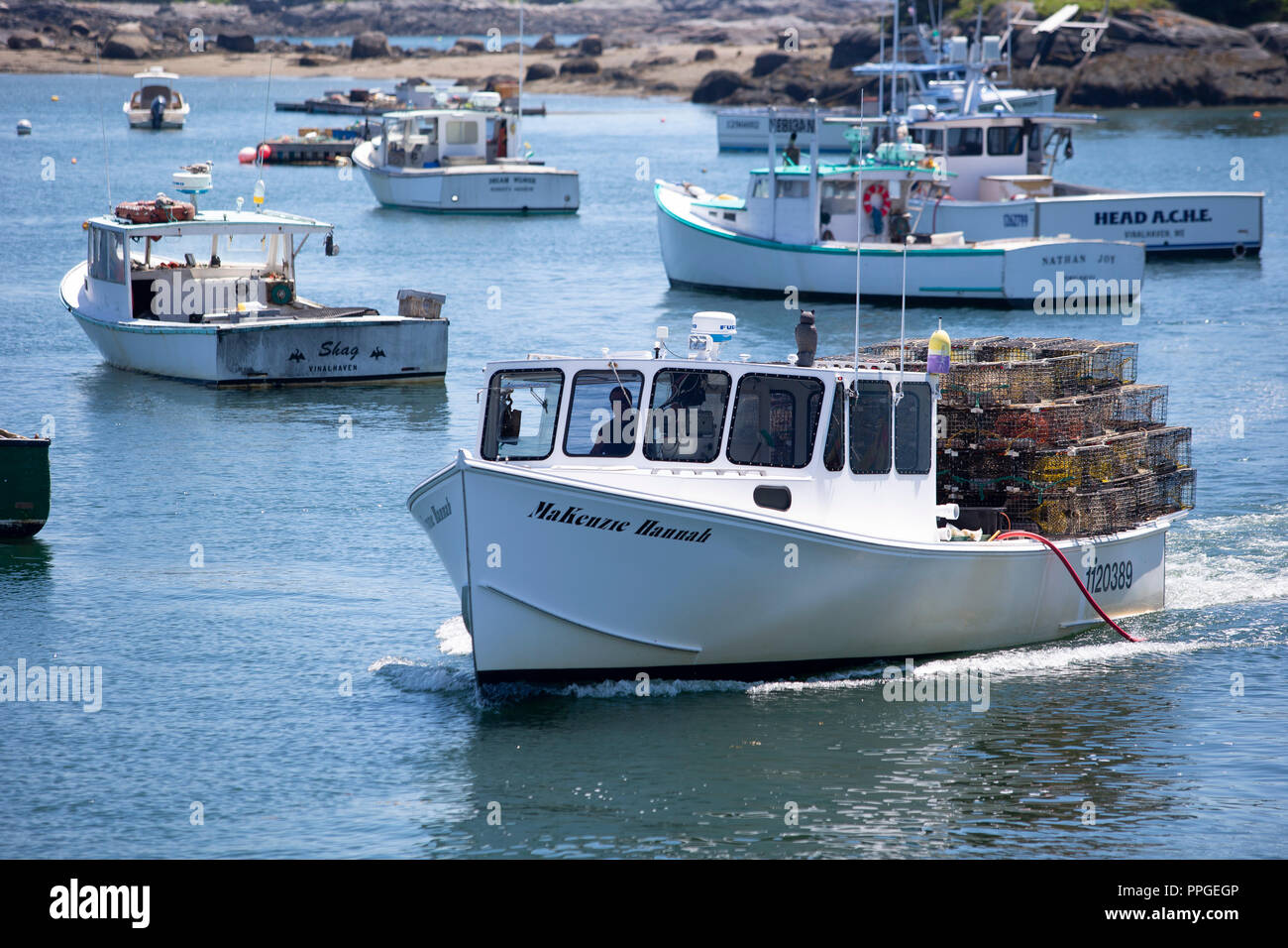 Lobster fishermen in their boats on the island of Vinalhaven, Maine