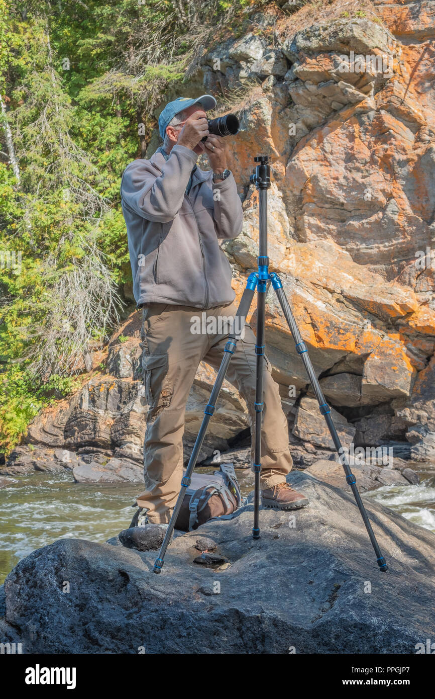 Photographer shooting pictures in a remote area of Hastings County near Bancroft Ontario, Canada. Stock Photo