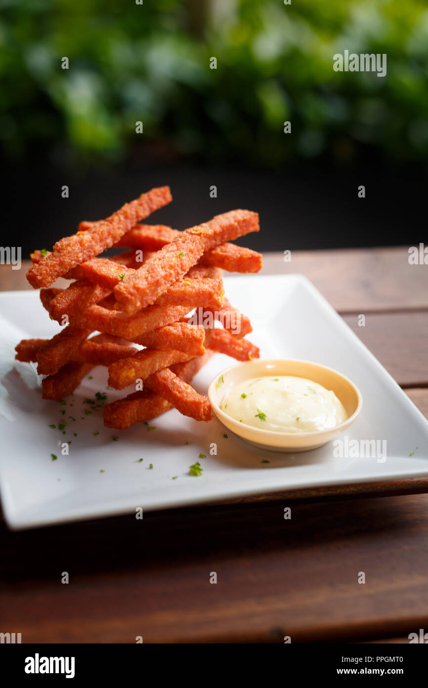 Food Photography / gastronomy close up shot of sweet potato fries with dipping sauce. Stock Photo