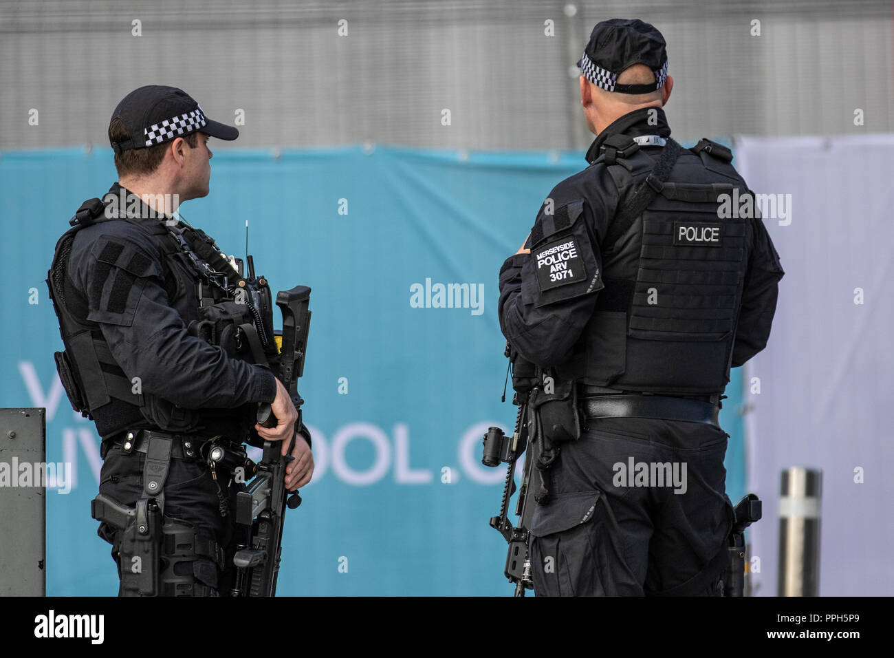 Authorised firearms officer (AFO)  a British police officer in Liverpool, UK.  Weapons, policing, police, uniform, british, force, officer, law, armed, security, control, england, patrol, gun, weapon, firearm, military, handgun, pistol, security, crime, protection, patrol, enforcement, cop, crime, shot, danger, black uniforms, firearms and equipment of British Armed Police on duty at the Labour Party Annual Conference, 2018. Stock Photo