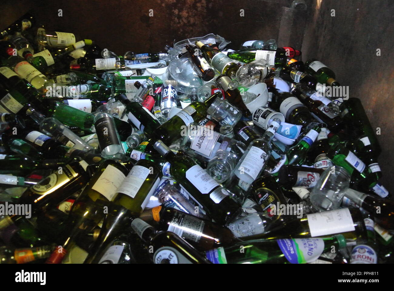 Glass bottles inside a bottle bank ready for recycling in England Stock