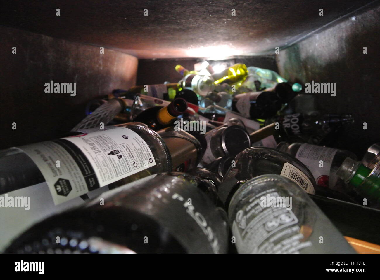 Glass bottles inside a bottle bank ready for recycling in England Stock