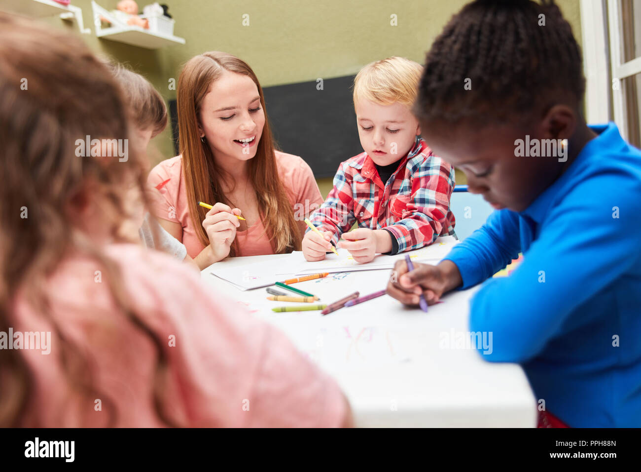 Group Of Kids Paints With Felt Tip Pens Pictures In Drawing Class