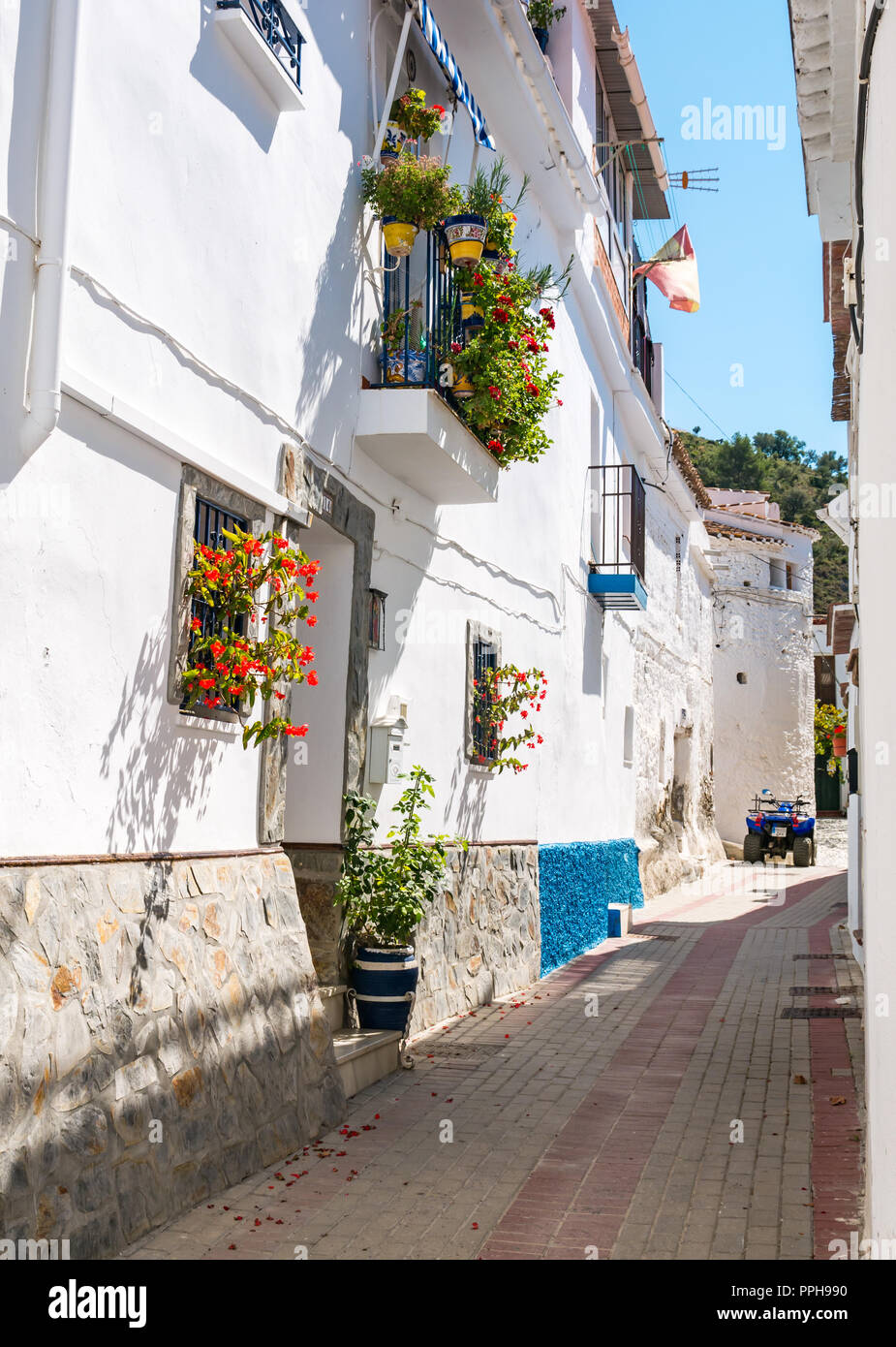 White houses with quadbike in narrow street, old Moorish village, Mudejar route, Salares, Axarquia, Andalusia, Spain Stock Photo