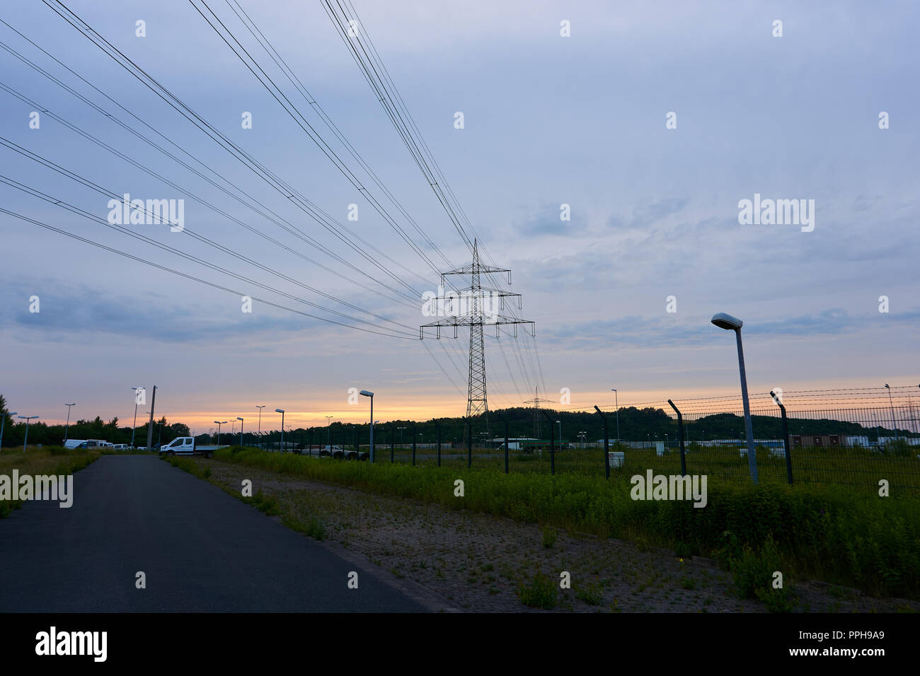 power pole in a sunset with wires Stock Photo