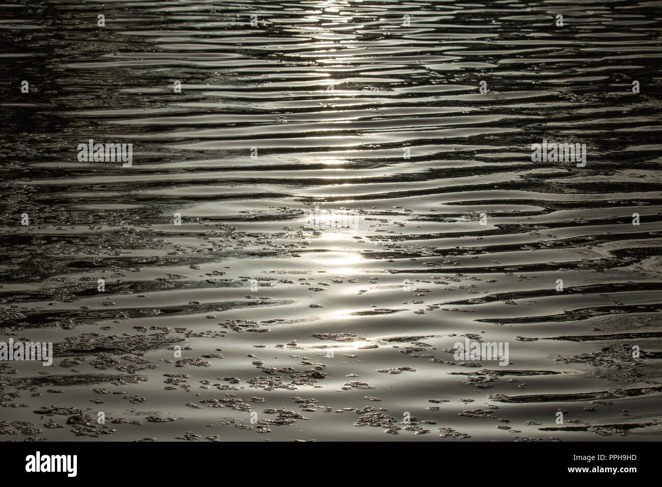 Sunshine in water with shadow lines Stock Photo