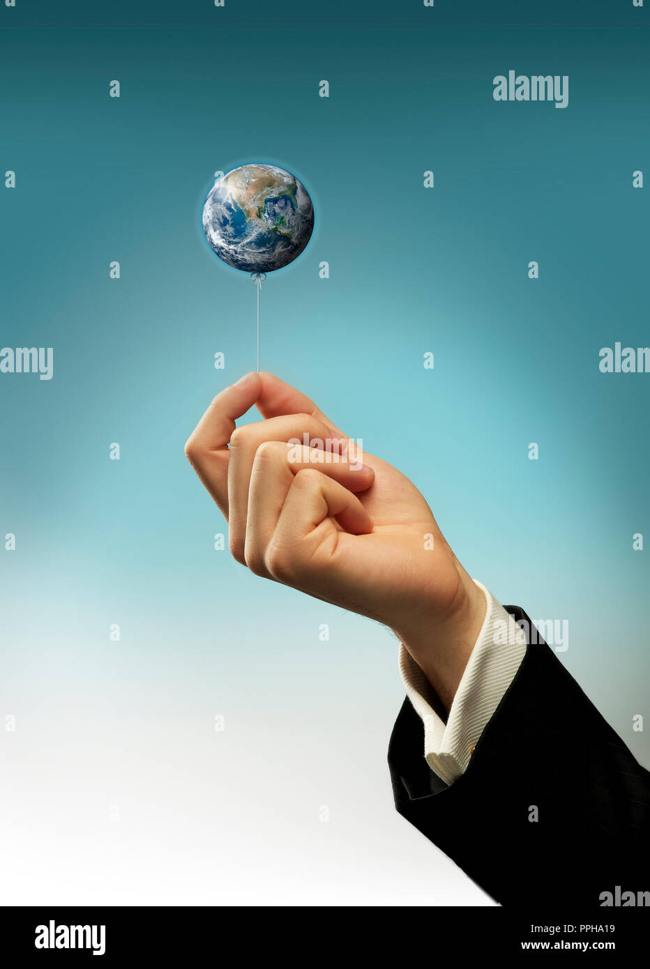 Concept Hand of a business man holding a string of earth balloon Stock Photo