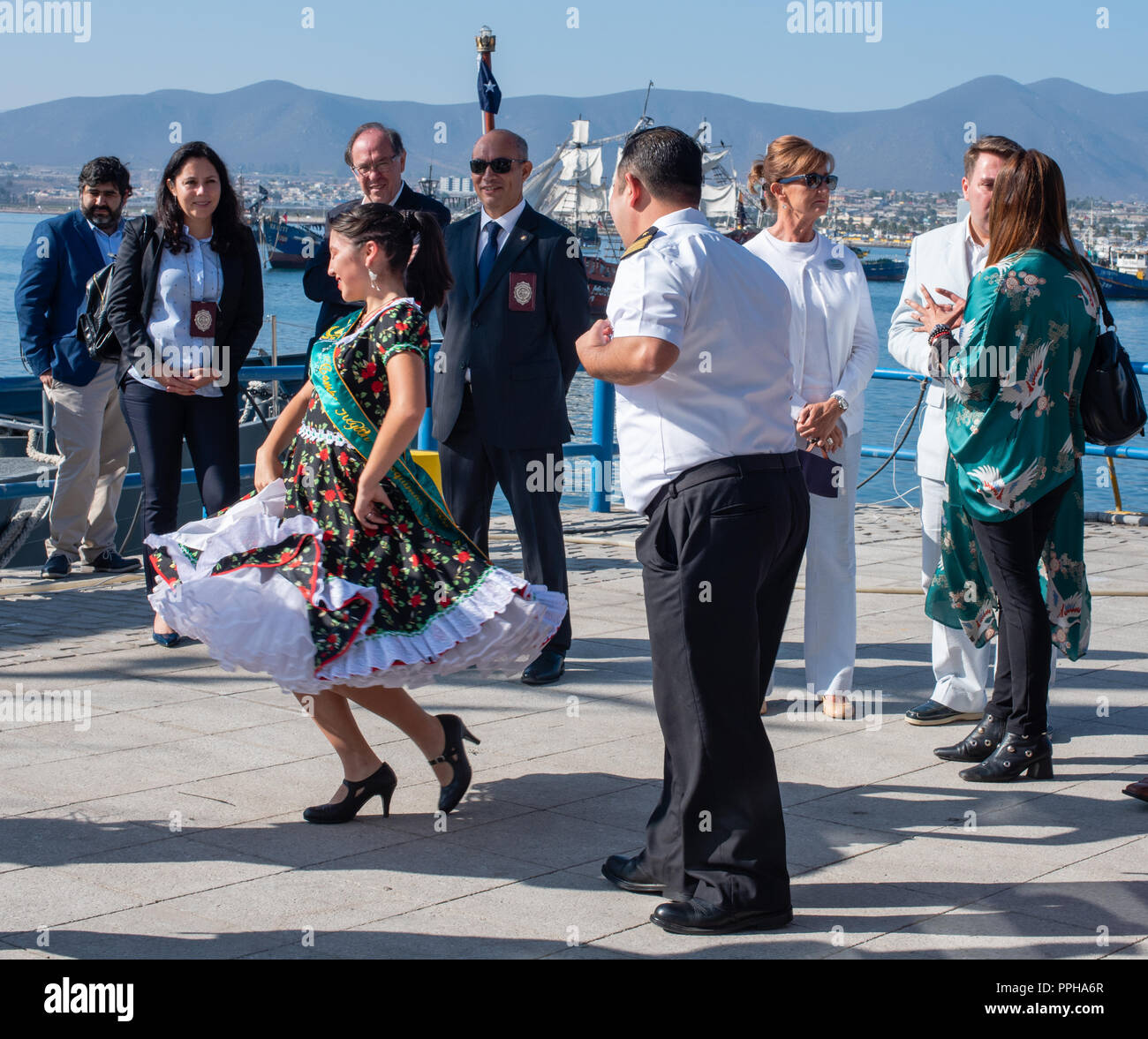 Coquimbo, Chile -- April 7, 2018. A Chilean woman greets tourists with a native dance performed in a traditional costume. Stock Photo