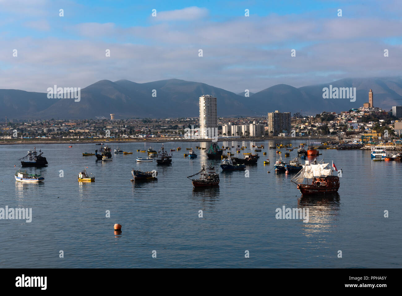 Coquimbo, Chile -- April 7, 2018. A number of small and midsized boats are anchored in the harbor of Coquimbo, Chile. Stock Photo