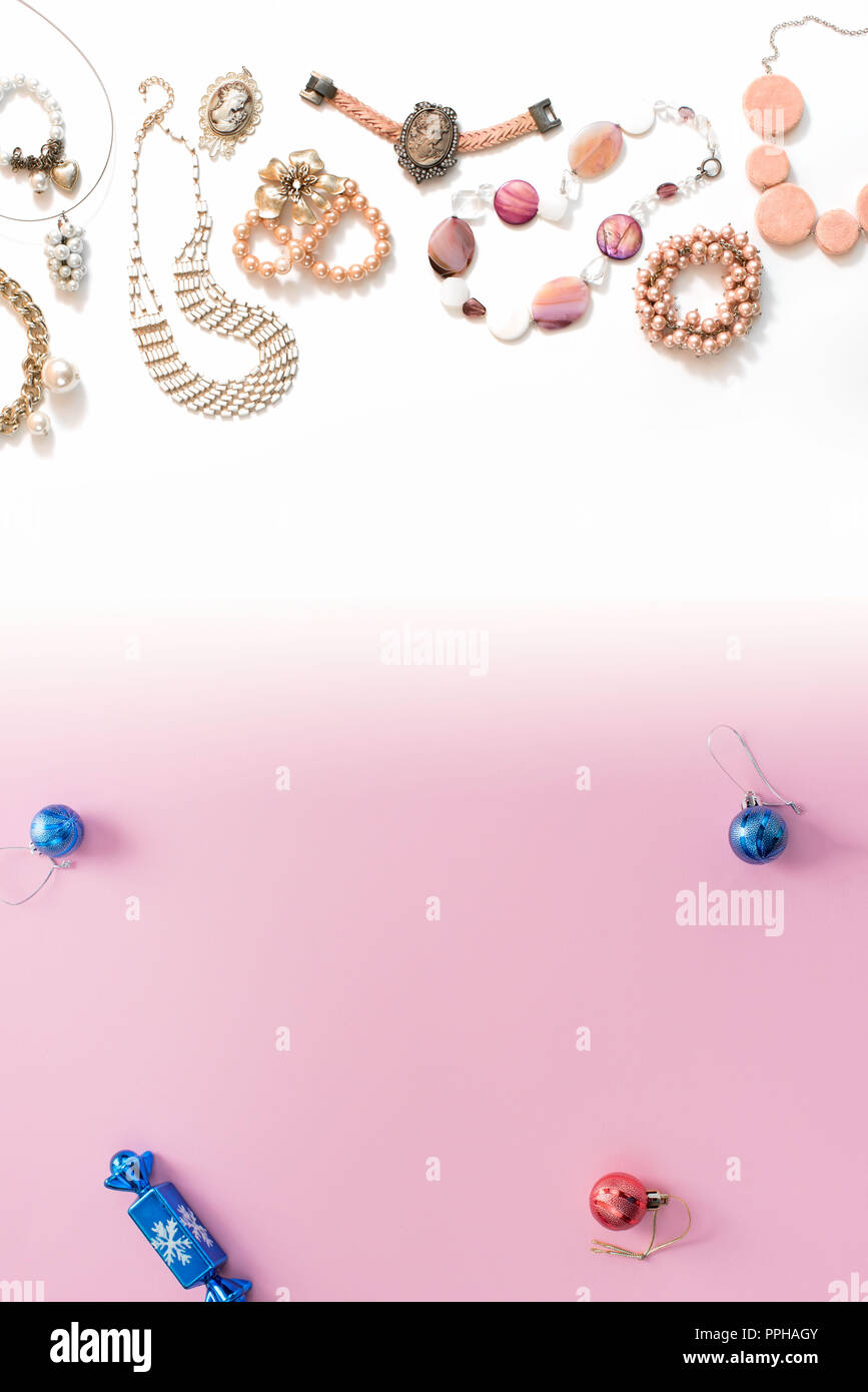 Christmas composition flat lay the balls jewelry necklace bracelet vintage pearls on a pink gradient background white to blue. Top view copy space ver Stock Photo