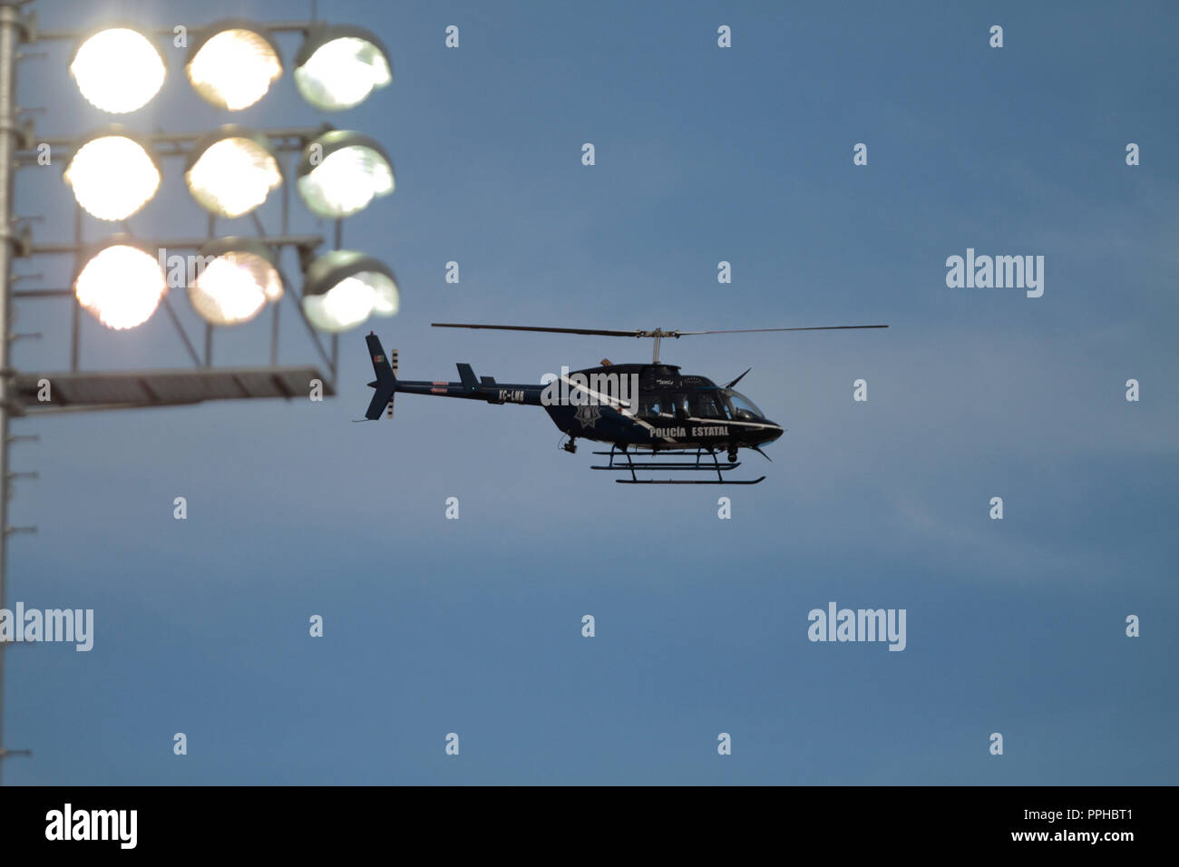 SEGURIDAD. Aeronave, helicóptero de la Policia Estatal sobrevolando cerca de las lamparas del Estadio Sonora , durante el primer dia de acción en la Stock Photo