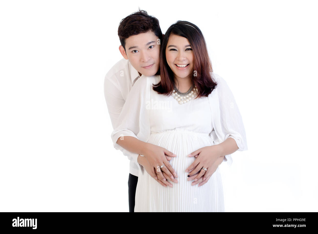 Man embracing her pregnant woman from behind Stock Photo - Alamy