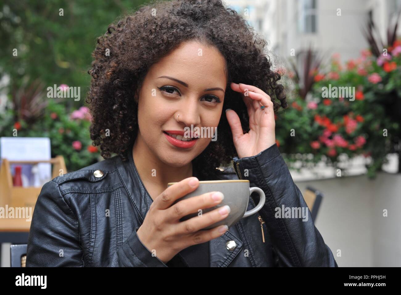 Beautiful Mixed Race Model Relaxing Outside Stock Photo 220434301