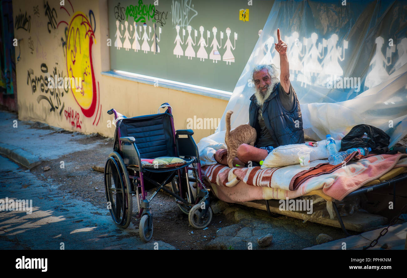 Athens Greece/June 18, 2018: Homeless man in Athens sitting on bed with ...