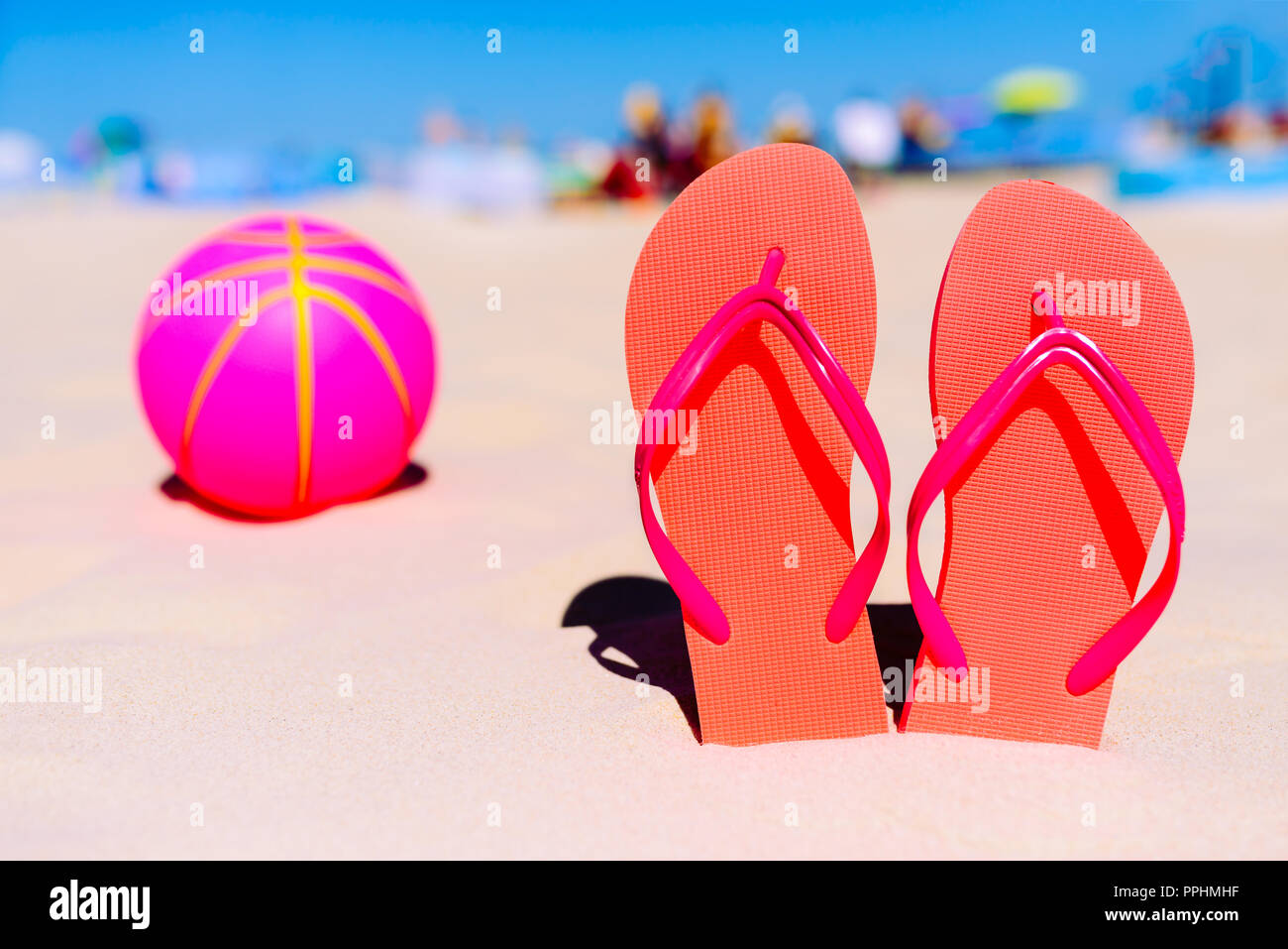 Flip flops, beach balll on the sandy beach. Summer vacation concept ...