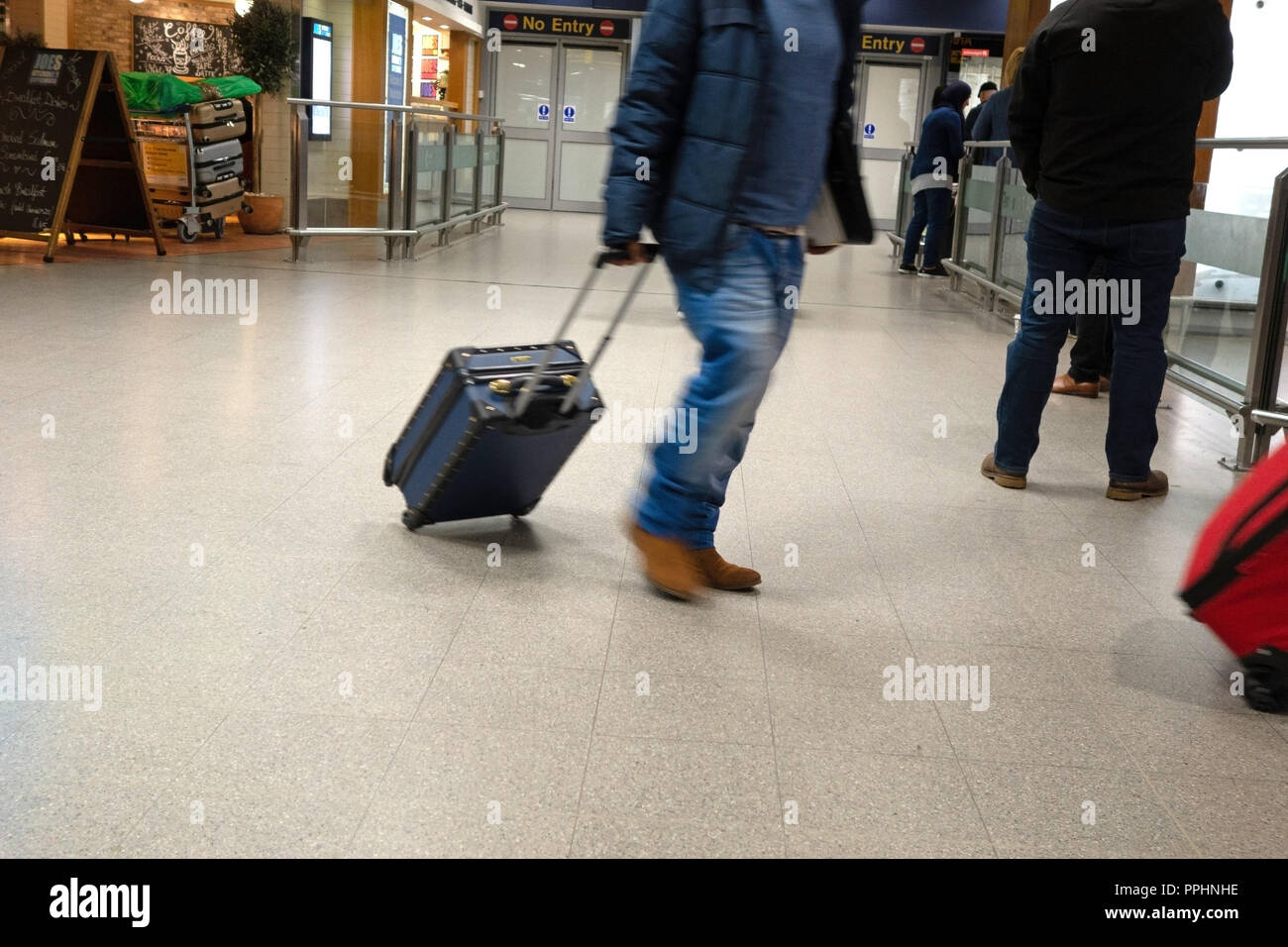 One passenger walking through the airport after arriving at Manchester