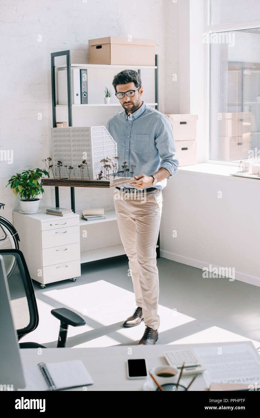 handsome architect holding architecture model in modern light office Stock Photo