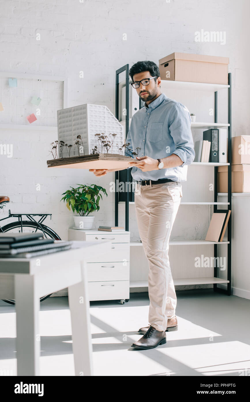 handsome architect holding architecture model in office Stock Photo
